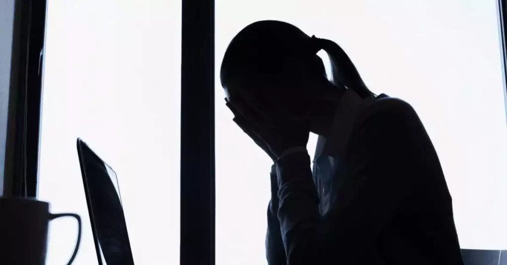 silhouette of woman with migraine