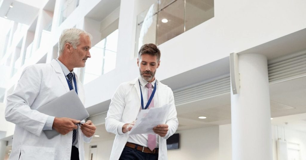 Two doctors consulting notes