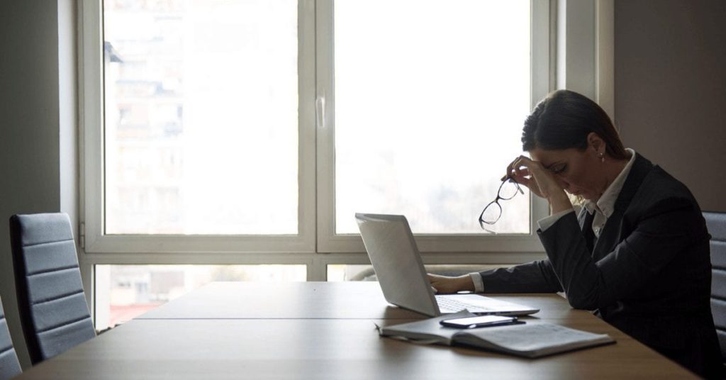 Woman getting a migraine at work