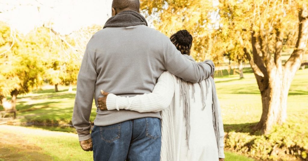 Couple waking in park thinking about migraine and stroke risk