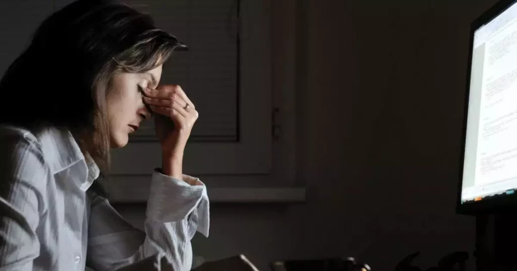 Woman with migraine experiencing light sensitivity