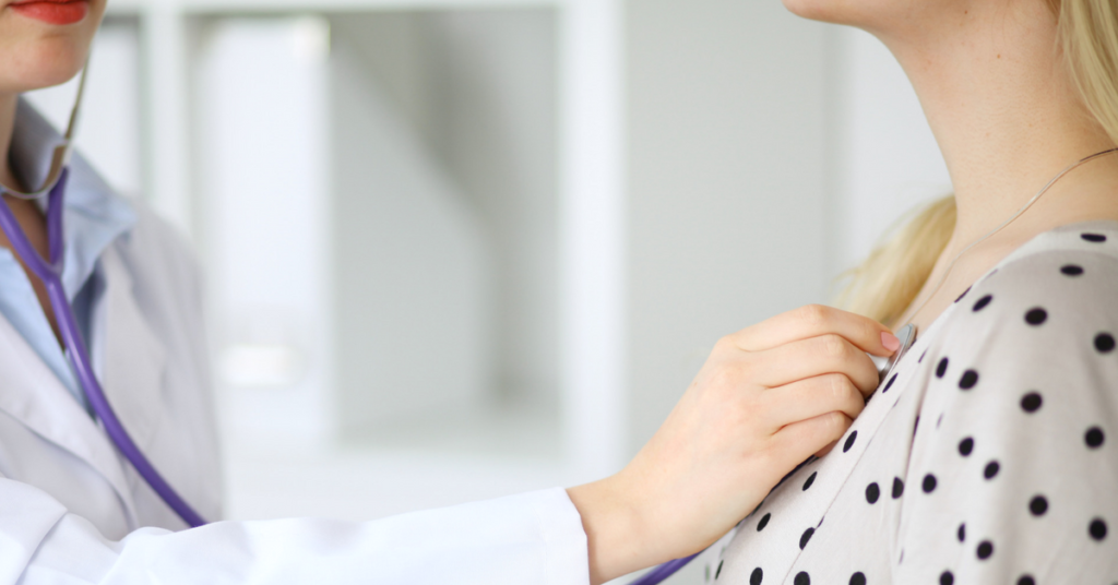 doctor with stethoscope on patient's chest