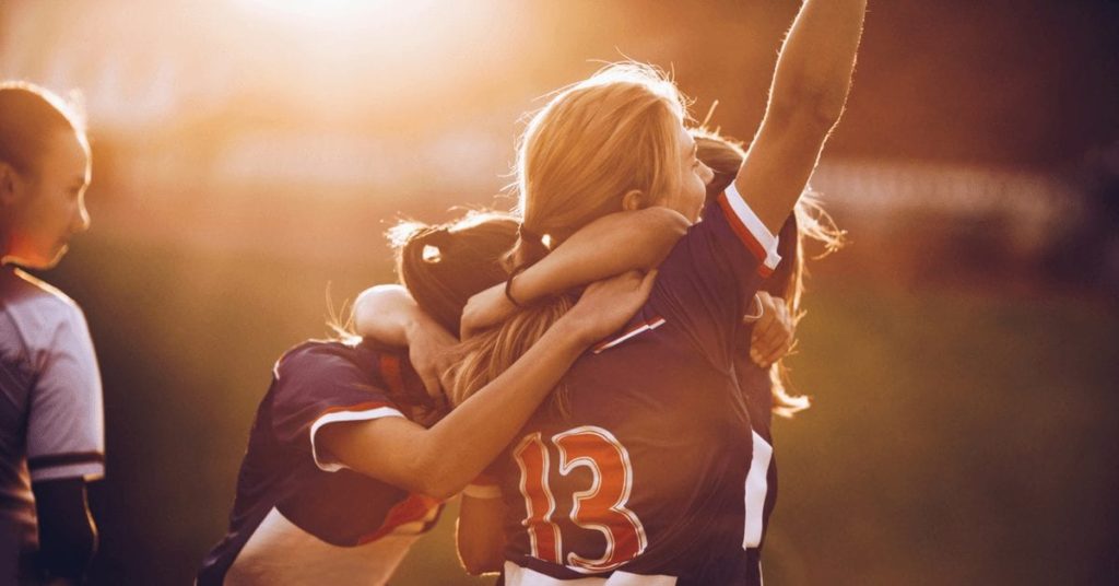 young women celebrating sports victory