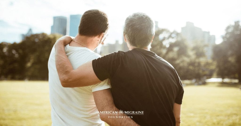 men with arms around each other