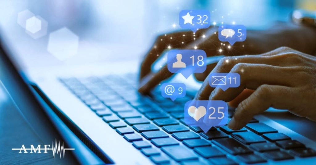 Hands typing with superimposed social media icons