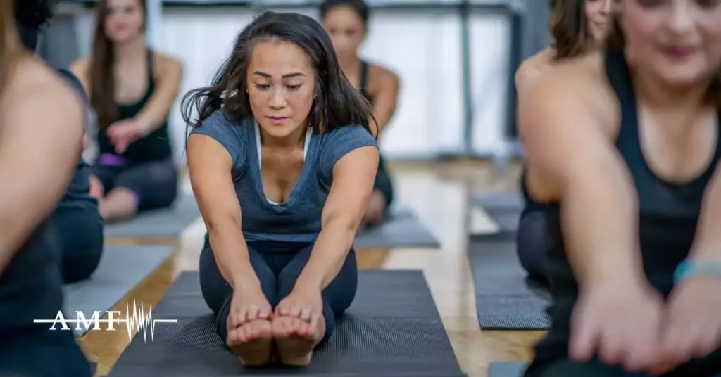 Women doing yoga as one of their complementary migraine treatments.
